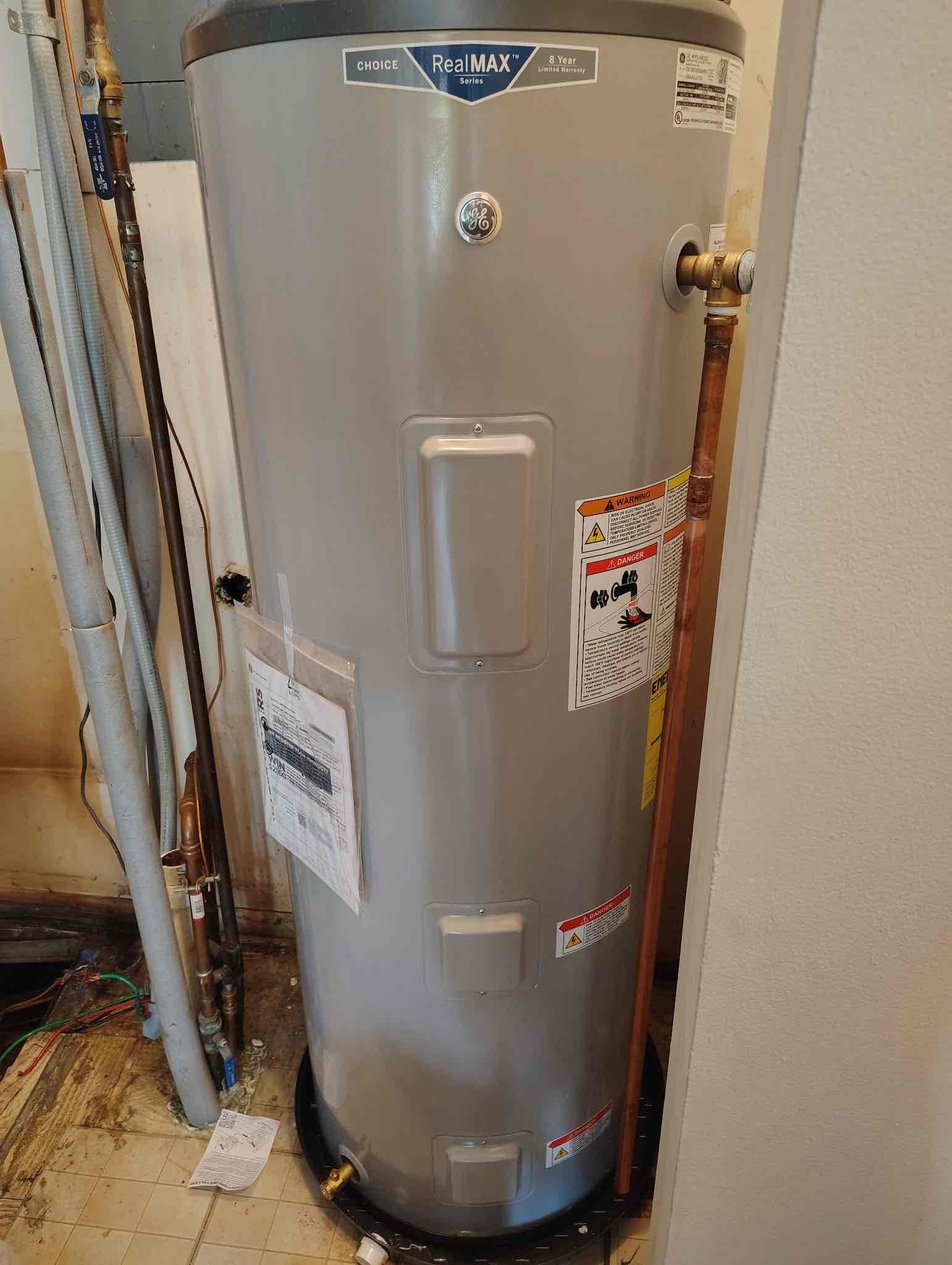 A newly installed water heater connected in a basement