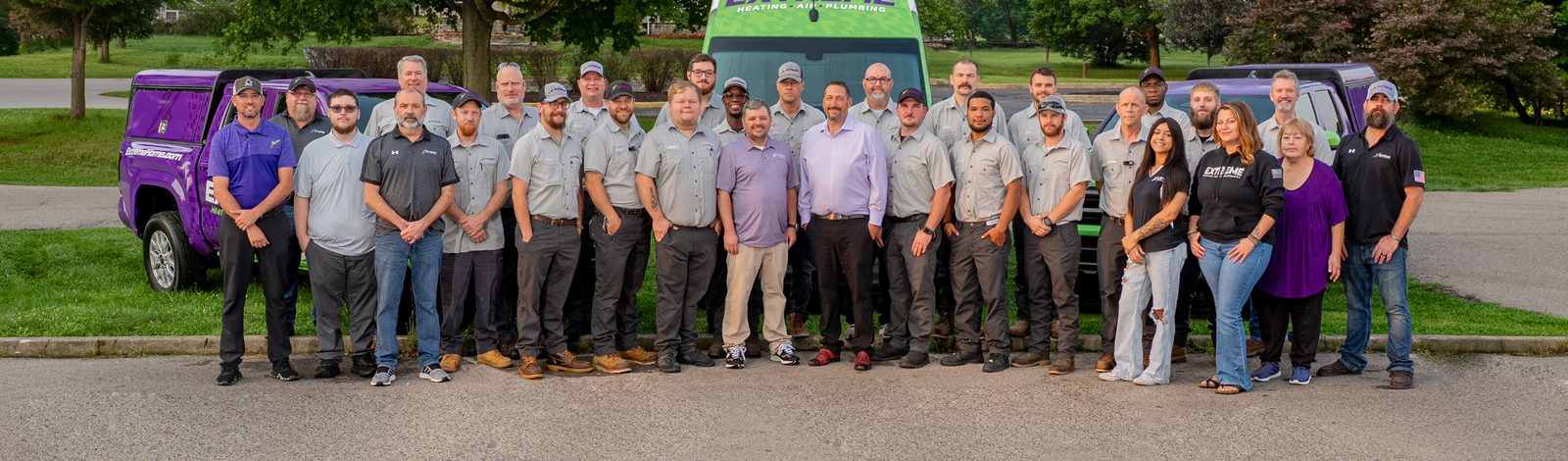 The Extreme Heating, Air, Plumbing team in front of a company service van