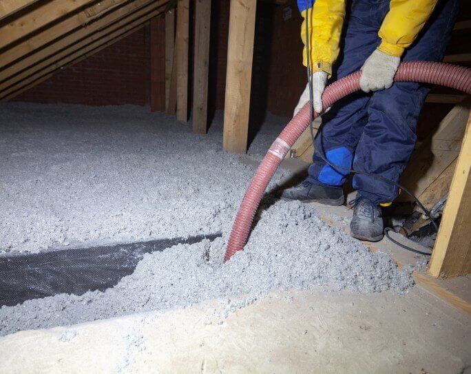 Man Blowing Insulation in Attic