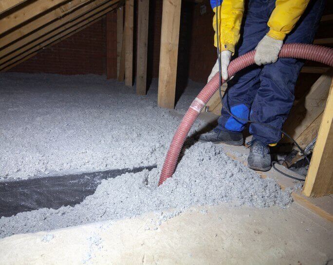 Insultion Man Blowing Insulation in Attic
