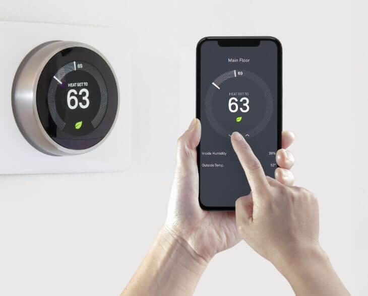 Smart Thermostat Person Adjusting smart thermostat from their phone